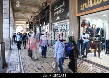 Tunis, Tunisia. 11th May, 2020. People walk past stores in Tunis, Tunisia, on May 11, 2020. Amid the improvement of the situation, Tunisia started on May 4 partial lifting of the lockdown, which includes three stages, from May 4 to 24, from May 24 to June 4, and from June 4 to 14. Credit: Adel Ezzine/Xinhua/Alamy Live News Stock Photo