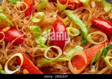 Veg Pad Woon Sen or Thai Glass Noodle Stir-Fry or Pad Thai close up texture. Vegetarian Pad Woon Sen is a Thai dish of glass bean noodles, tomatoes, c Stock Photo