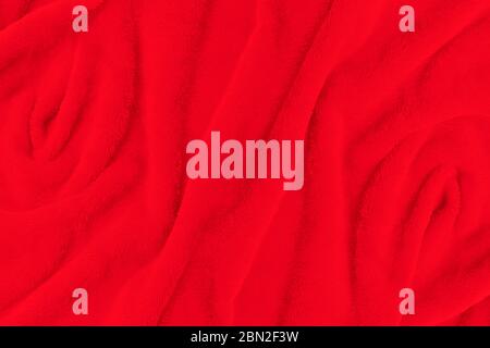 Red fabric texture background. Abstract cloth backdrop with soft waves. Stock Photo