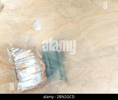 Image of a paint brush left on plywood Stock Photo
