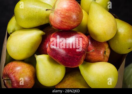 pears and apples on a dark background Stock Photo