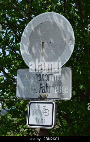 ragged old traffic sign on a dirt road Stock Photo