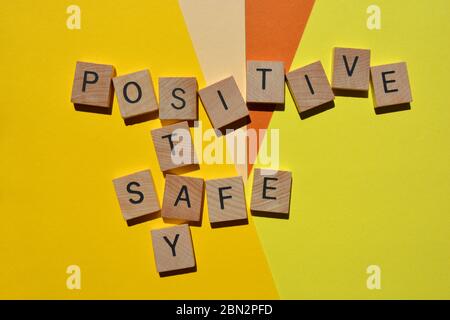 Positive, Stay, Safe, crossword isolated on yellow background Stock Photo