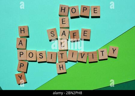 Positivity, Happy, Healthy, Safe, Hope, crossword isolated on green Stock Photo