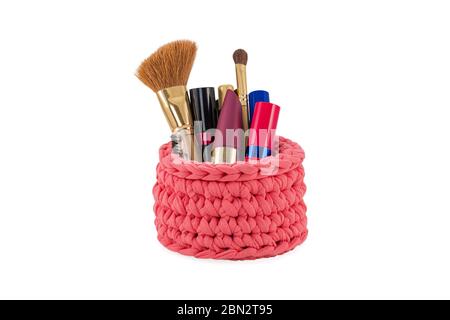 red handmade knitted cosmetic bag with female makeup isolated on white background Stock Photo