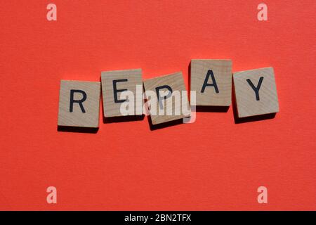 Repay, word in wooden alphabet letters isolated on red background Stock Photo