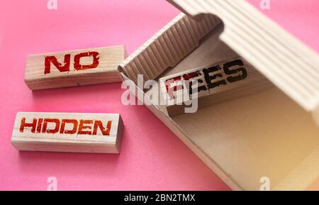 No hidden fees words on wooden blocks in box and outside. Taxes and fees financial business concept Stock Photo
