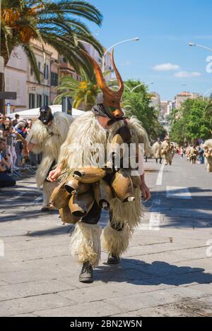 Sardinia folk festival, a man dressed as a Boe - a traditional masked figure in sheepskin and bells, participates in the Cavalcata festival, Sassari Stock Photo