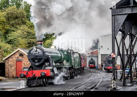 BR 'Hall' 4-6-0 No. 6990 'Witherslack Hall' departs Grosmont on the North Yorkshire Moors Railway during their Autumn Steam Gala Stock Photo