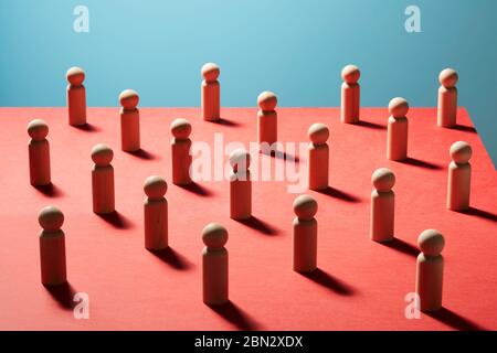 Wooden pawn chess pieces on red surface Stock Photo