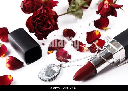 Lipstick dried rose flower and pendant Stock Photo