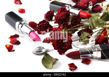 Lipsticks dried rose flower and pendant Stock Photo