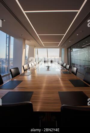 Long wood conference table in empty modern conference room Stock Photo