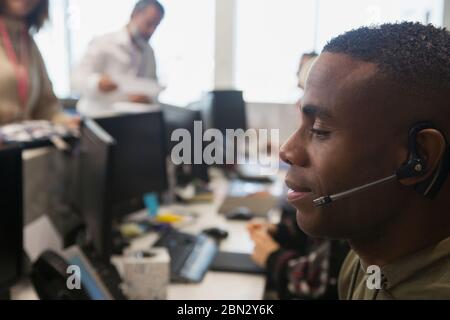 Businessman with headset working in office Stock Photo