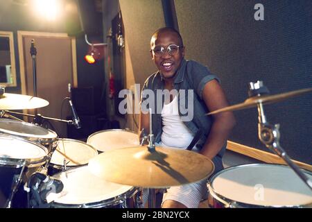 Portrait confident male drummer at drum kit Stock Photo