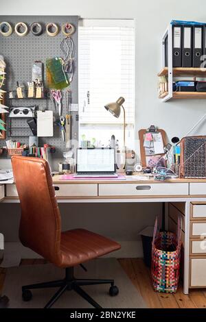Laptop on desk in creative home office Stock Photo
