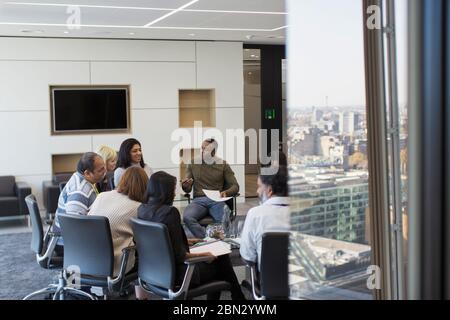 Business people talking in circle in conference room meeting Stock Photo