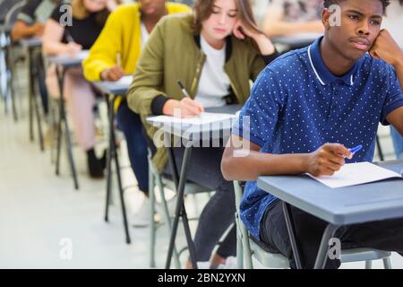 Focused high school students taking exam Stock Photo