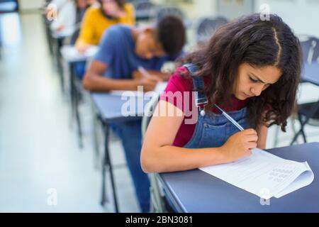 Focused high school girl student taking exam Stock Photo