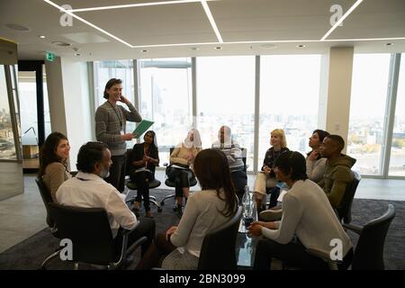 Business people meeting in circle in conference room Stock Photo