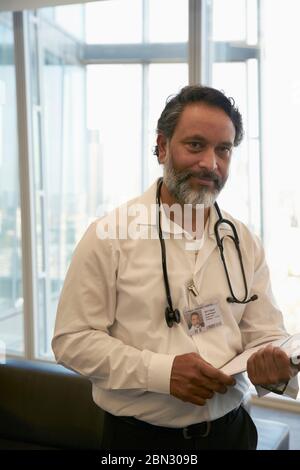 Portrait confident male doctor in office Stock Photo