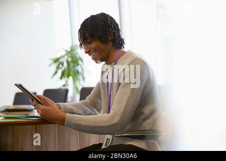 Smiling businessman using digital tablet in office Stock Photo