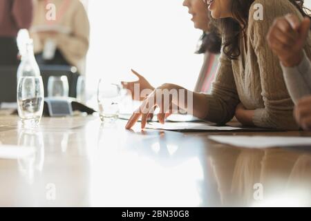 Business people with paperwork in sunny conference room meeting Stock Photo