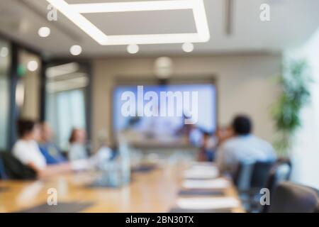 Defocused business people video conferencing in office meeting Stock Photo