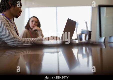 Business people planning at laptop in conference room meeting Stock Photo