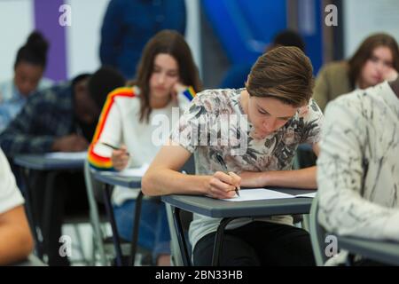 Focused high school students taking exam Stock Photo