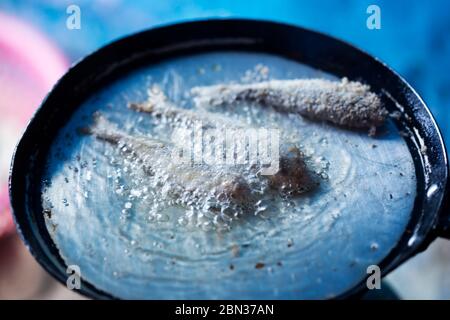 Frying small sardines fish, Chefchouen, Morocco Stock Photo