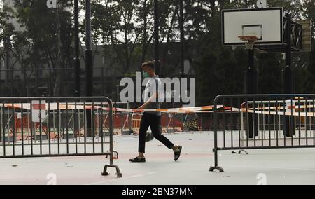 May 12, 2020, Hong Kong, CHINA: A masked man walk past barricaded VICTORIA PARK.With less than one month for Hong Kongers to attend annual JUNE 4th CANDLE LIGHT VIGIL at the Victoria Park, citizens are concerned whether or not Victoria Park will be reopened for annual CANDLE LIGHT VIGIL at the traditional venue under the continued prohibition order to ban group gatherings at the public places. Victoria Park has been opened for use to Hong Kong citizens annually to pay respect to the sacrificed Chinese citizens since 1989.May-12, 2020 Hong Kong.ZUMA/Liau Chung-ren (Credit Image: © Liau Chung-re Stock Photo