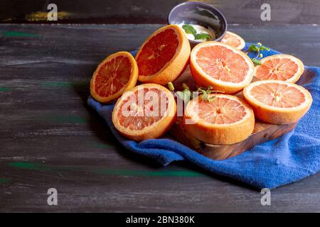 Grapefruits on blue background and decorated plate, to make juices or to enjoy in an afternoon at home Stock Photo