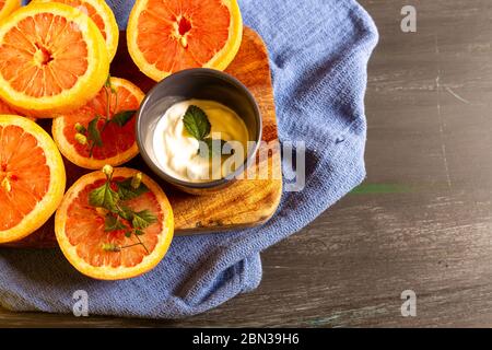 Grapefruits on blue background and decorated plate, to make juices or to enjoy in an afternoon at home Stock Photo