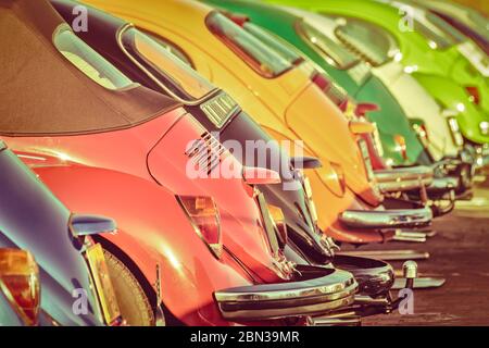 Retro styled image of a row of colorful classic cars Stock Photo