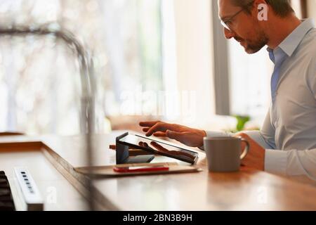 Businessman using digital tablet, working from home Stock Photo
