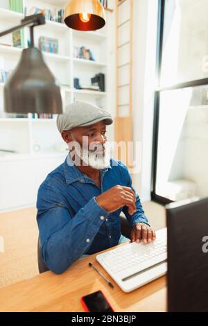 Man using computer, working from home Stock Photo
