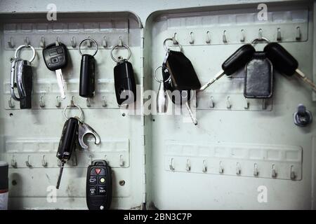 Keys on hooks in auto repair shop Stock Photo