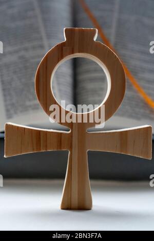 Bible and the Ankh,  symbol from ancient Egypt, known as the key of life or the cross of life. The ankh as a form of the Christian cross, symbolizing Stock Photo