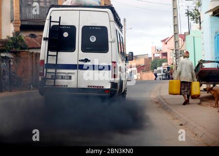 Old minibus emitting black smoke on road. Pollution.  Antananarivo. Madagascar. Stock Photo