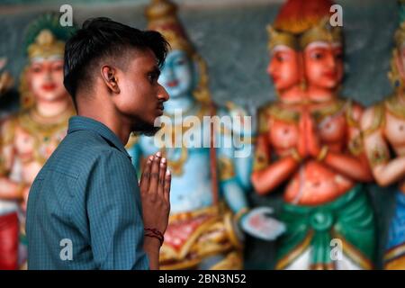 Sri Mahamariamman Hindu Temple.  Man praying in temple.  Kuala Lumpur. Malaysia. Stock Photo