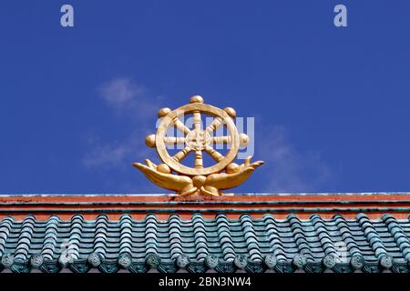 Huynh Quang Buddhist temple.  The dharma wheel, or dharmachakra in Sanskrit, is one of the oldest symbols of Buddhism.  Chau Doc. Vietnam. Stock Photo