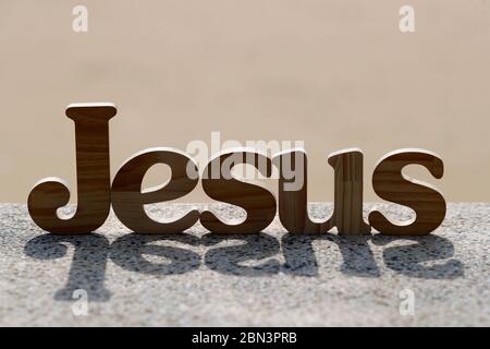 Wooden letters forming the word JESUS. Christian symbol. Stock Photo
