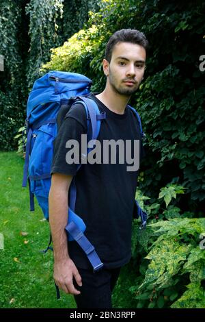 Young man wearing a backpack in Montrouge, France. Stock Photo