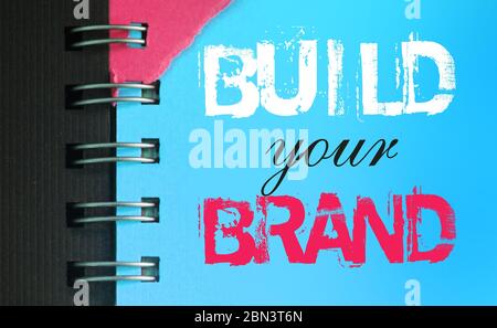 Create your brand text message words on sky blue page of copyybok in white and pink. Business startup concept. Stock Photo