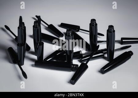 Mascara brushes and containers on white background Stock Photo