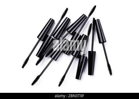 Mascara brushes and containers on white background Stock Photo