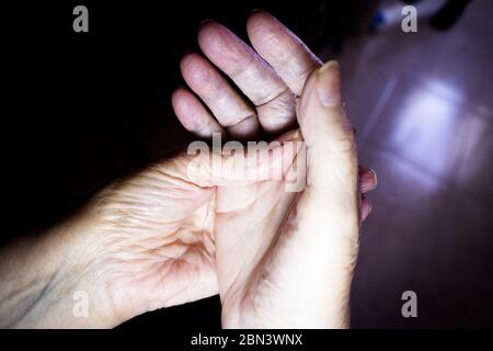 Hands of elderly woman doing a selfmassage. Manual physiotherapy Stock Photo