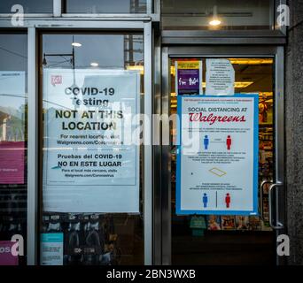Signs in the window of a Walgreens pharmacy in New York on Saturday, May 2, 2020 inform customers that COVID-19 testing is not at this location and that customers are expected to comply with social distancing protocols. (© Richard B. Levine) Stock Photo