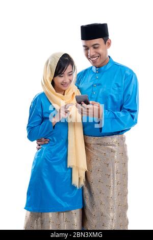 muslim couple using mobile phone isolated over white background Stock Photo